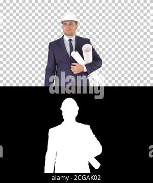 Male architect in a suit and hard hat walking with blueprints and briefcase, Alpha Channel Stock Photo