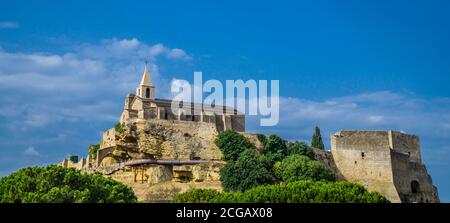 view of the Church of Saint-Sauveur and the medieval fortification of Fos-sur-Mer, Bouches-du-Rhône department, southern France Stock Photo