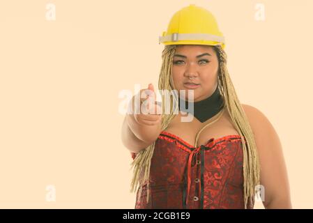 Young fat Asian construction woman pointing at camera Stock Photo