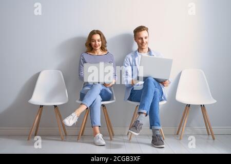 Young couple is using a laptop on white wall background Stock Photo