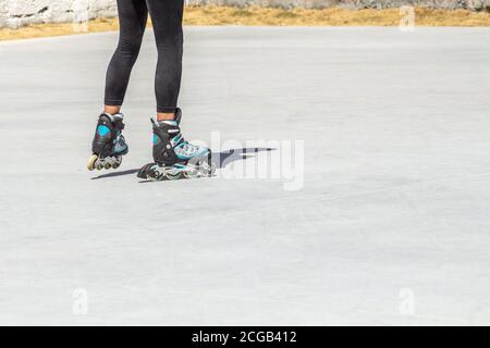 Close-up of in line skates seen from behind on a gray background with good copy space Stock Photo