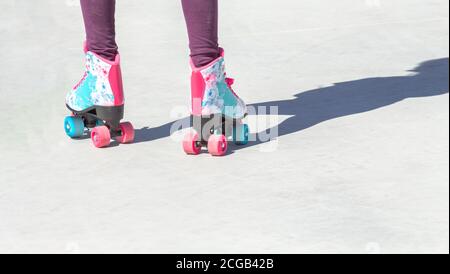 Close-up of colorful roller skates seen from behind on a gray background with good copy space Stock Photo