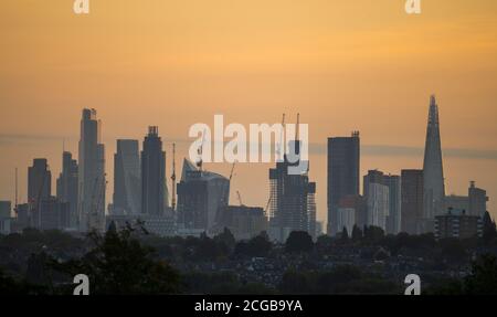 London, UK. 10 September 2020. Autumn dawn over skyscrapers in central London with tree covered suburbs of south west London in the foreground. Credit: Malcolm Park/Alamy Live News. Stock Photo