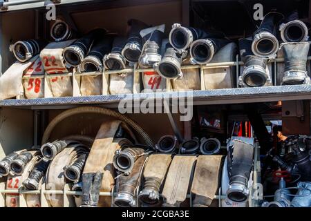Rescue fire truck equipment. Compartment of the rolled up fire hoses on a fire engine Stock Photo
