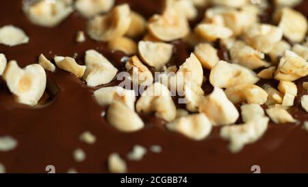 Detail of crushed hazelnuts in hot chocolate. Close-up of dark chocolate Stock Photo