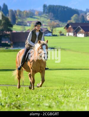 Woman riding out in falltime morning in bavarian Allgäu Stock Photo