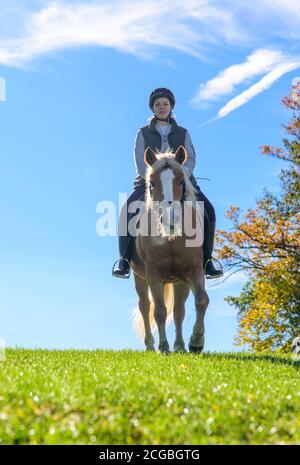 Woman riding out in falltime morning in bavarian Allgäu Stock Photo