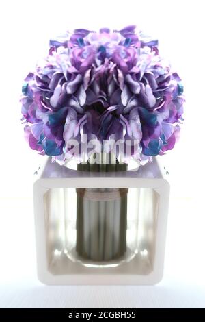 Artificial purple flower in flower pot on white background Stock Photo