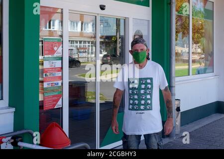 masked older man standing outside of supermarket wearing sheep t.shirt in passive protest at enforced wearing of face mask lenti zala county hungary Stock Photo