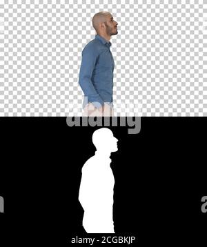 Confident in his style model walkin with hands in pockets, Alpha Channel Stock Photo