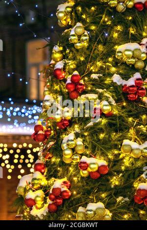 Decorated Christmas tree on blurred, sparkling background. Vertical Stock Photo