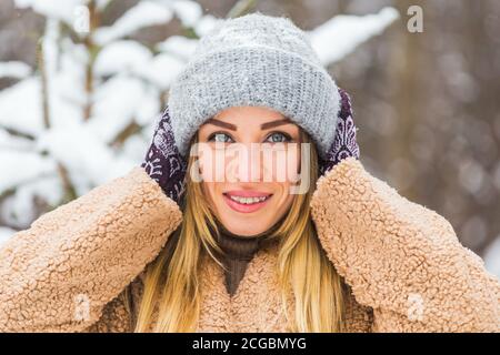 Portrait of a beautiful woman with braces on teeth. Smiling girl with dental braces. Happy smiling woman with braces in winter nature. Dental Health Stock Photo