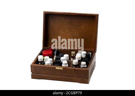 brown wooden box with cosmetic oil jars and vials open on white background Stock Photo