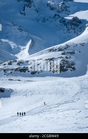 Zermatt, Switzerland - Feb 18 2020: People walking in mountains in the Matterhorn region in winter. Stock Photo