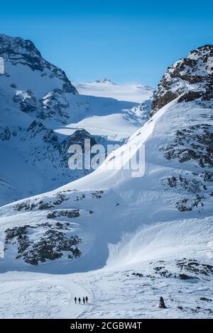 Zermatt, Switzerland - Feb 18 2020: People walking in mountains in the Matterhorn region in winter. Stock Photo