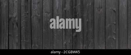 Panoramic detail of an old black wooden wall Stock Photo
