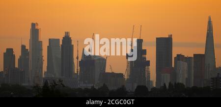 London, UK. 10 September 2020. Golden Autumn dawn over skyscrapers in a panoramic view of City of London where office occupancy remains low during the prolongued Covid-19 pandemic, with The Shard London Bridge towering over high rise buildings south of the river Thames. Credit: Malcolm Park/Alamy Live News. Stock Photo