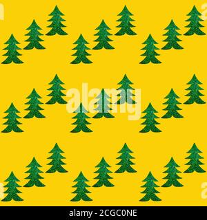Christmas background. Festive creative seamless pattern of diagonal rows of green Christmas trees on yellow backdrop. Stock Photo