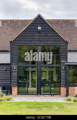 Exterior view of a converted barn/mill in Essex, UK, featuring beautful steel windows. Stock Photo