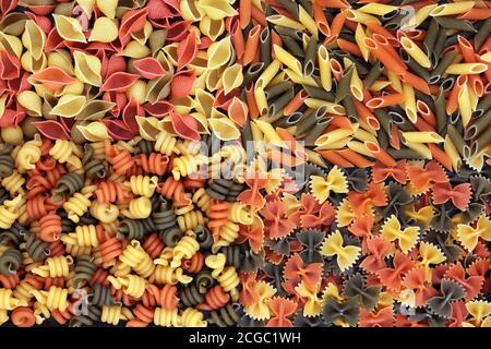 Italian tricolore dried pasta abstract background. Health food smart carb concept. Flat lay, top view. Stock Photo