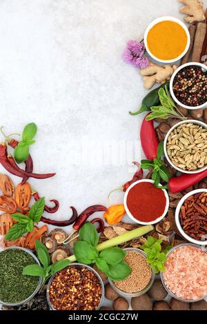 Herb and spice border with fresh and dried herbs and spices on light grunge background with copy space. Flat lay. Stock Photo