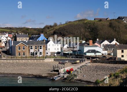 Fishing boat returning to the pretty harbour at Little Haven, Pembrokeshire, Wales Stock Photo