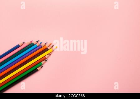 Many different colored pencils and on pastel pink background Stock Photo