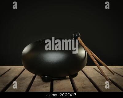 Steel tongue drum rare music playing instrument, made from propane tank and also known as tank drum or hank drum similar to Pantam.  On wooden surface Stock Photo