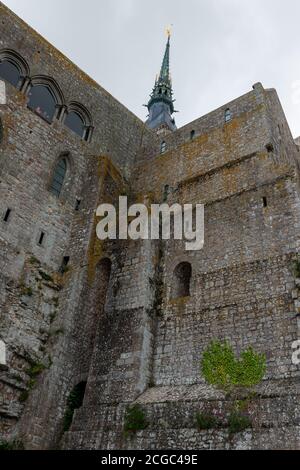 the Romanesque church of Mont Saint Michel designed by William of Volpiano towering over the tidal island, Brittany, France Stock Photo