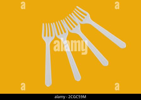 four plastic white forks on background Stock Photo