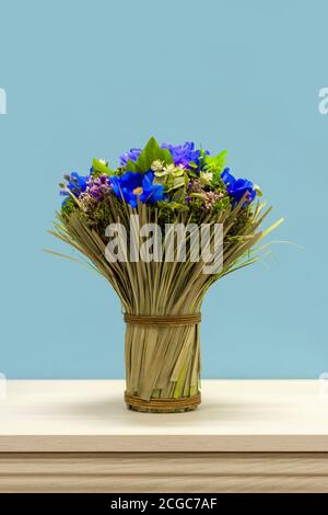A bouquet of wildflowers tied with a rope on the dresser. Stock Photo