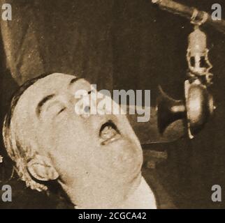 1922 - An old portrait photograph  of George Robey  who was known to his fans as 'The Prime Minister of Mirth' performing on radio . Robey  whose real name was Sir George Edward Wade, CBE (1869 –  1954),   was an English comedian, singer and actor in musical theatre. He was also one of the greatest  variety, music hall and pantomime  performers of the late 19th and early 20th centuries starring in the Royal Command Performance in 1912. In addition he was a semi-professional sportsman, playing cricket and football , starred on stage in Shakespearean plays and had a modest success in film. Stock Photo