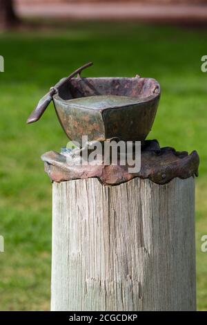 Mandurah, Western Australia - August, 2020: Bronze sculpture of a boat with paddle at Mandurah artwalk. The sculpture is a part of public artwork Thre Stock Photo