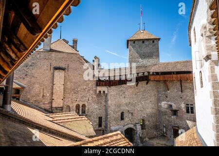 Chillon castle interior courtyard wide angle view with tower taken from wall walk in Vaud Switzerland Stock Photo