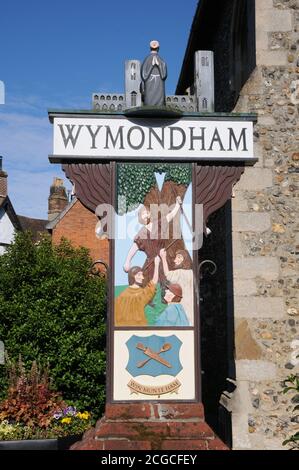 Town sign, Wymondham, Norfolk. One side depicts Robert Kett, and a wood-turner is shown on the other side.  The town’s arms of a wooden spoon and spig Stock Photo