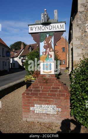 Town sign, Wymondham, Norfolk. One side depicts Robert Kett, and a wood-turner is shown on the other side.  The town’s arms of a wooden spoon and spig Stock Photo