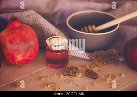 Jewish National Holiday. Rosh Hashana with honey, apple and pomegranate on wooden table. Stock Photo