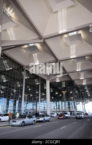 Entrance to the glass fronted Malaga airport terminal three building with cars parked in the foreground, Malaga, Spain. Stock Photo