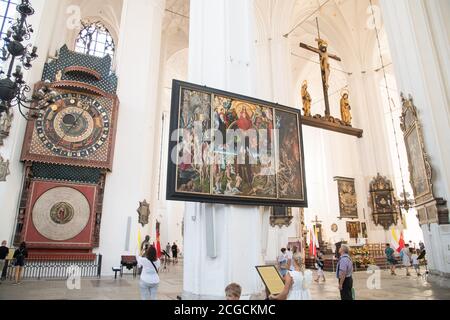 Astronomical clock and copy of The Last Judgement by Hans Memling in Gothic Bazylika Mariacka (St. Mary's Church) in Main City in historic centre of G Stock Photo