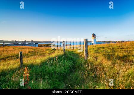 The lighthouse and coastguard cottages at Arnish Point on the entrance to Stornoway harbour on the Isle of Lewis in Scotland Stock Photo