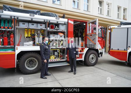 Berlin, Germany. 10th Sep, 2020. Karsten Göwecke (l), Permanent Representative of the State Fire Director, and Andreas Geisel (SPD), Senator of the Interior, stand in front of one of the fire engines during the handover of three new fire engines for disaster control. The three MB Atego 1327 AF 4x4 vehicles will be distributed at various locations of the volunteer fire brigade. Credit: Jörg Carstensen/dpa/Alamy Live News Stock Photo