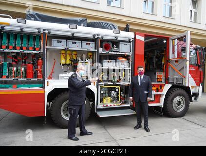 Berlin, Germany. 10th Sep, 2020. Karsten Göwecke (l), Permanent Representative of the State Fire Director, and Andreas Geisel (SPD), Senator of the Interior, stand in front of one of the fire engines during the handover of three new fire engines for disaster control. The three MB Atego 1327 AF 4x4 vehicles will be distributed at various locations of the volunteer fire brigade. Credit: Jörg Carstensen/dpa/Alamy Live News Stock Photo