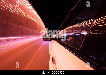 POV of car driving at night city with motion blur effect. Transportation and traffic concept