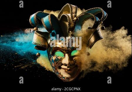Coloured powder explosion with Venice mask. Freeze motion, art background Stock Photo