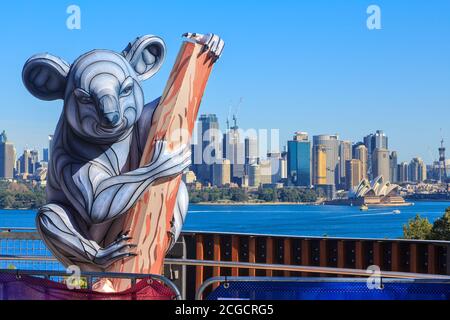 A koala sculpture at Taronga Zoo, Sydney, Australia, with the Sydney skyline in the background. Photographed during the annual 'Vivid Sydney' festival Stock Photo