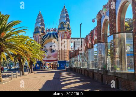 Sydney, Australia. The smiling face entrance to Luna Park and the decorative outer wall of the North Sydney Olympic Pool Stock Photo