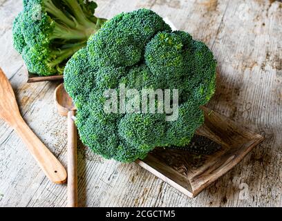 raw and uncooked broccoli on wooden background Stock Photo