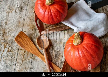 organic hokkaido pumpkin with stem on wooden table from above Stock Photo