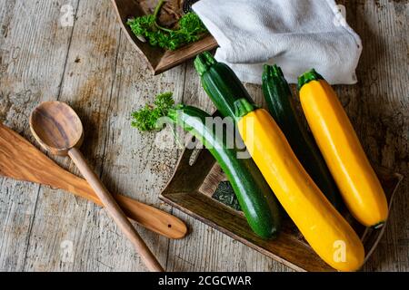 green zucchini and yellow zucchini on wooden table Stock Photo