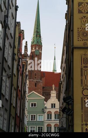 Gdansk, North Poland - August 15, 2020: Narrow passage through polish architecture building in the city center old town containing famous church Stock Photo